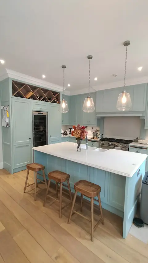 Duck-egg island kitchen with breakfast bar and pendant lights