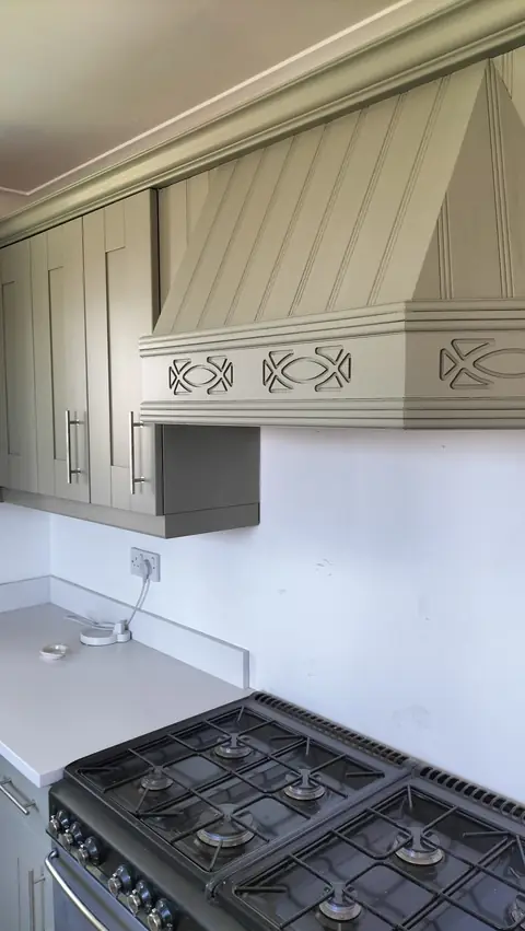 Grey-green shaker kitchen with a panelled cooker hood