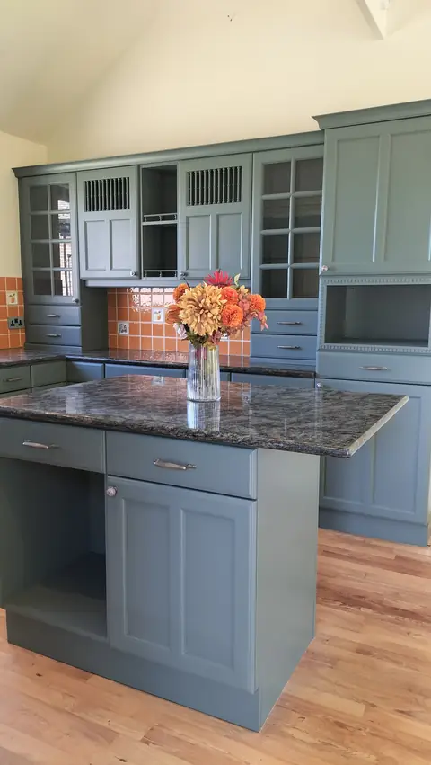 Green-grey kitchen with glazed dresser and island