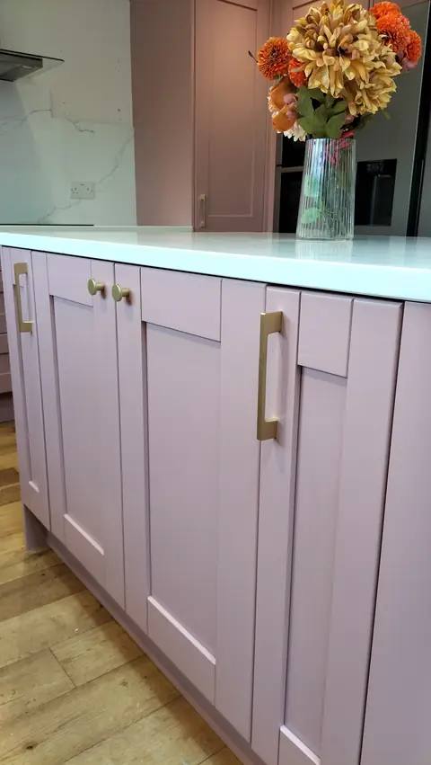 Dusky pink island with brass bar handles